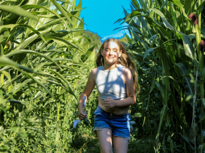 Girl running through maize maze at LDF